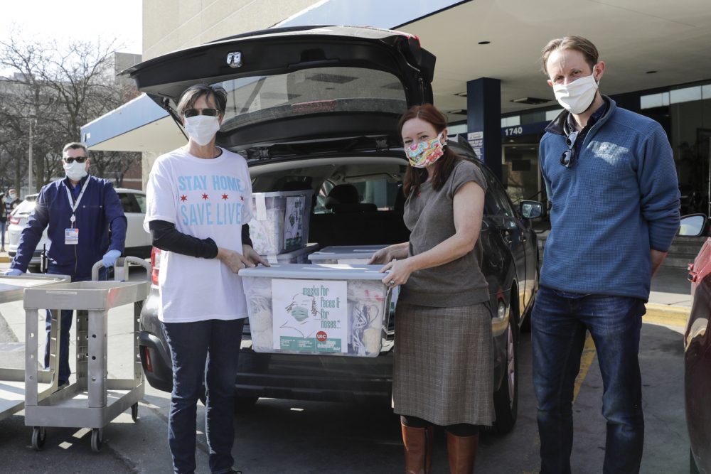 Chicago’s First Lady Amy Eshleman, left, helps Rebecca Rugg, dean of the College of Architecture, Design and the Arts, and Chris Plevin of the Chicago Shakespeare Theater, deliver 5,000 fabric face masks to the University of Illinois Hospital on April 3.