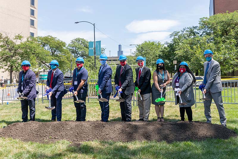 Groundbreaking for the new Outpatient Surgery Center & Specialty Clinics at UI Health on Aug. 13. From left, Chicago Ald. Walter Burnett, Jr., 27th Ward; UIC Vice Chancellor for Health Affairs Dr. Robert Barish; Illinois Sen. Omar Aquino, 2nd District; Illinois Senate President Don Harmon; UIC Chancellor Michael Amiridis; University of Illinois System President Timothy Killeen; Illinois Rep. Theresa Mah, 2nd District; Illinois Rep.-elect Lakesia Collins, 9th District; and University of Illinois Hospital & Clinics CEO Michael Zenn. (Photo: Joshua Clark/University of Illinois Chicago)