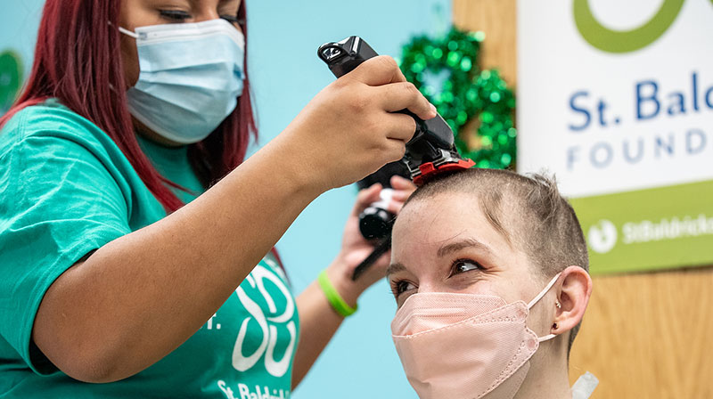 Ashley Roman, a UIC student majoring in mechanical engineering, gets her head shaved during the annual St. Baldrick’s fundraiser at the Children’s Hospital University of Illinois on Feb. 18. (Joshua Clark/University of Illinois Chicago)