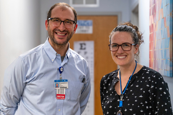 Photo of Dr.Sam Wainwright talking with a patient and her mother.