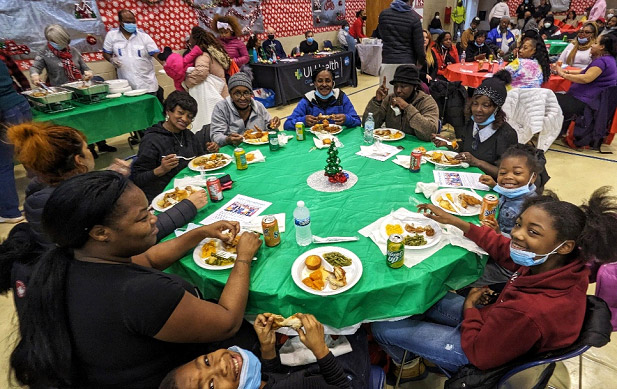 Photo of families at the table enjoying a meal